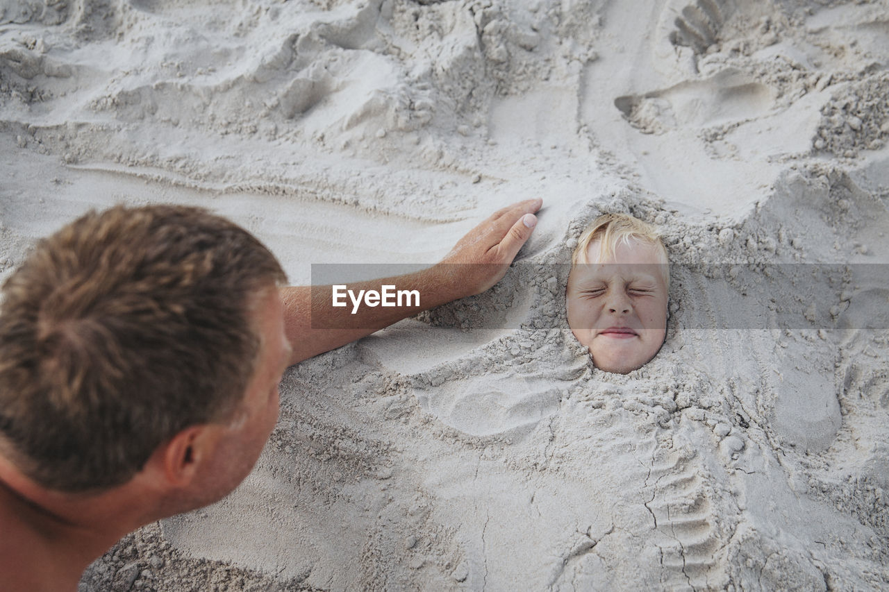 Boy buried in sand