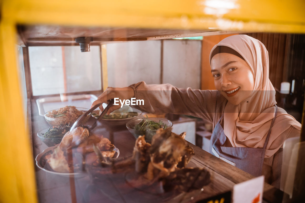 portrait of young man preparing food