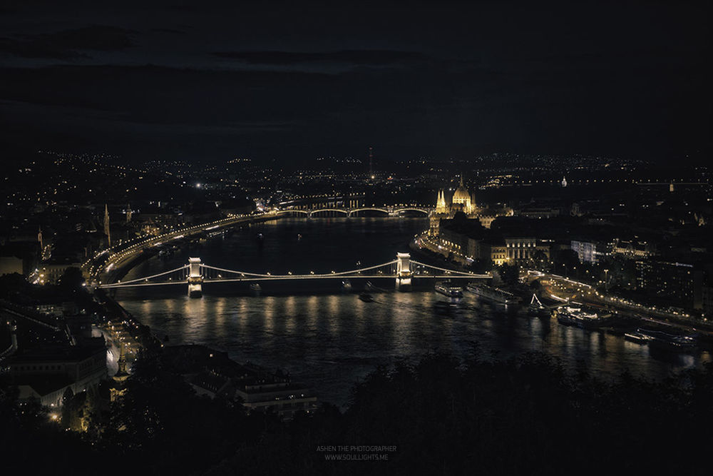 VIEW OF ILLUMINATED CITYSCAPE AT NIGHT