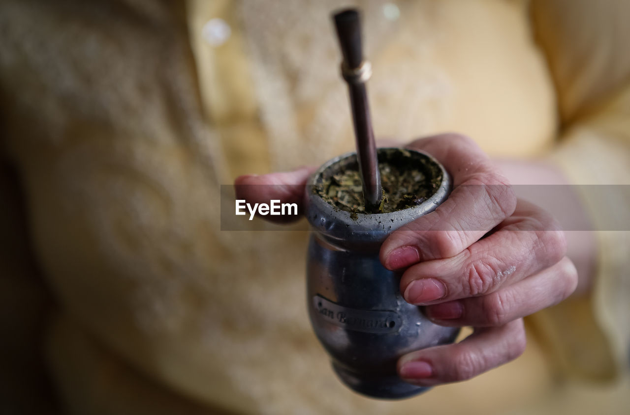 Midsection of woman holding yerba mate