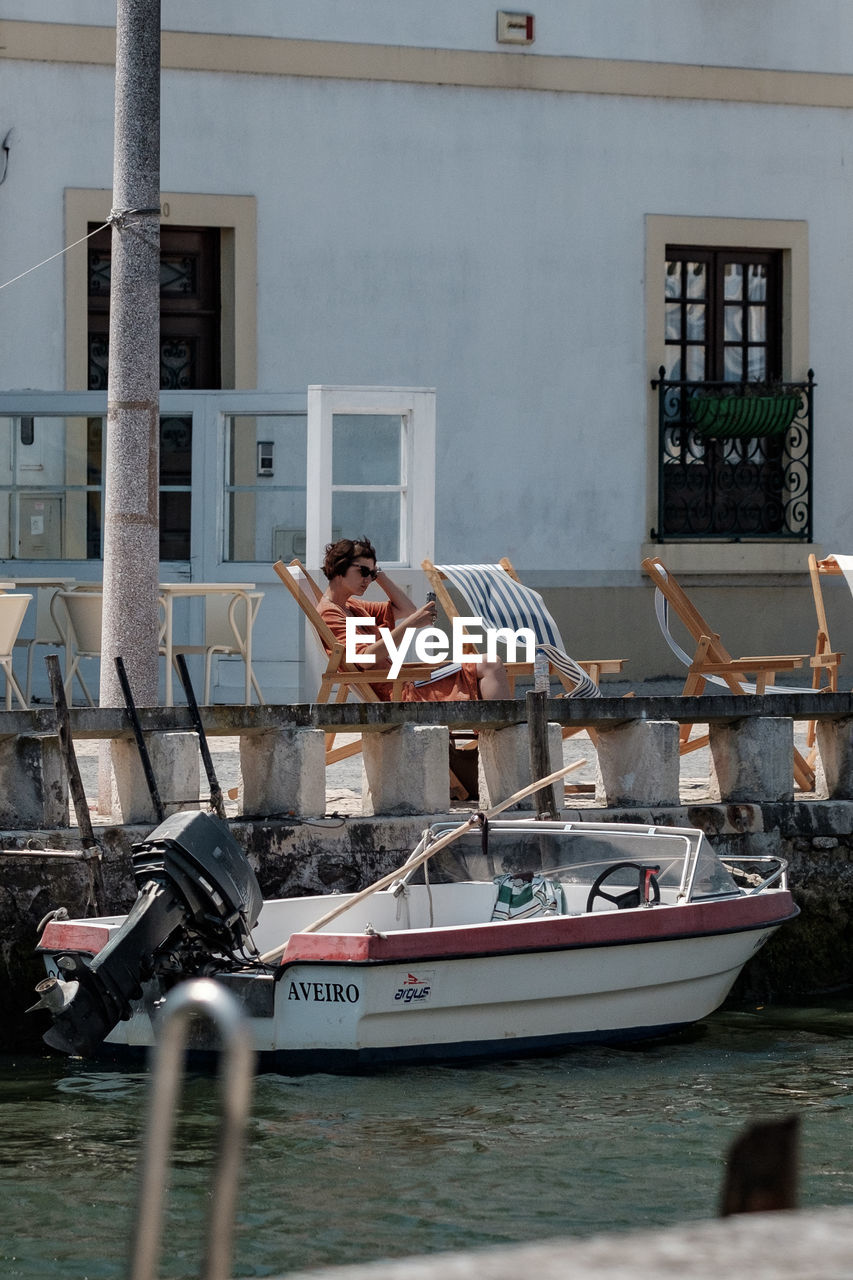 MAN WITH BOATS IN CANAL