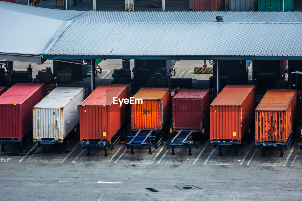 Row of containers against buildings in city