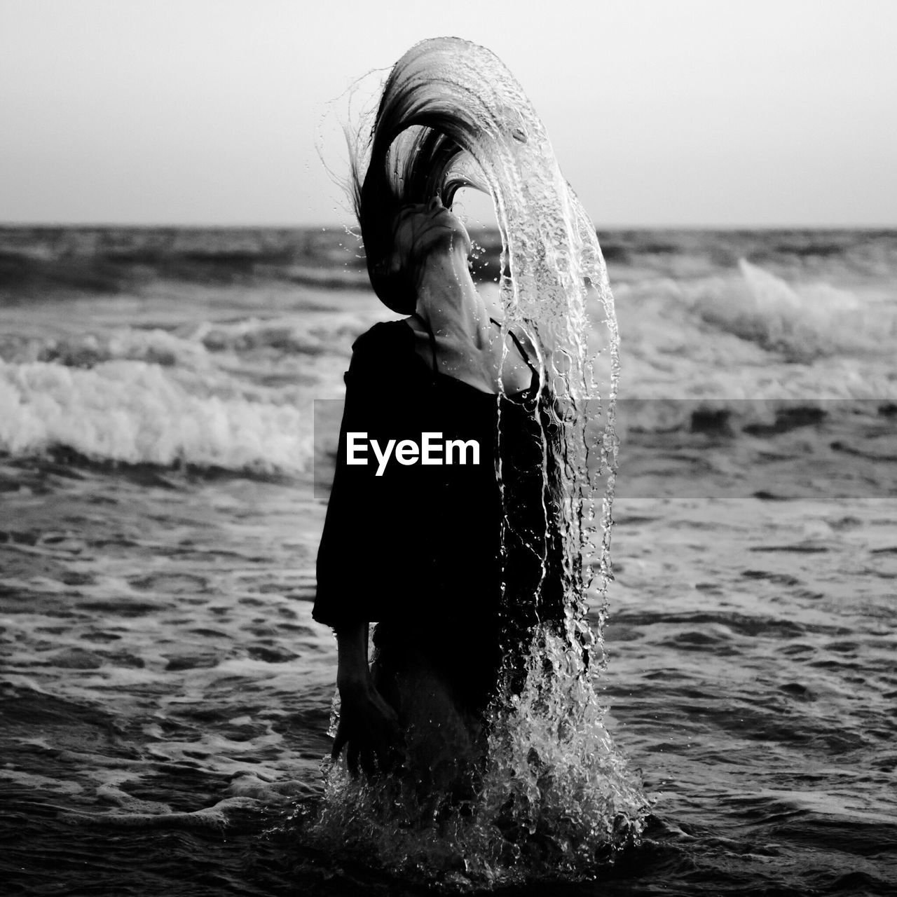 Woman splashing water in sea