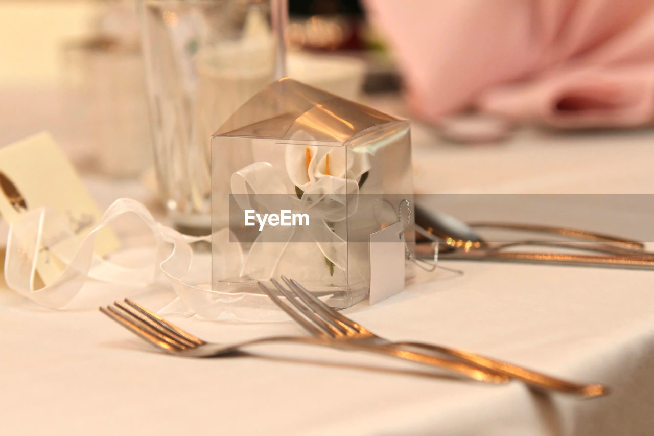 Close-up of ribbon and plastic box on table