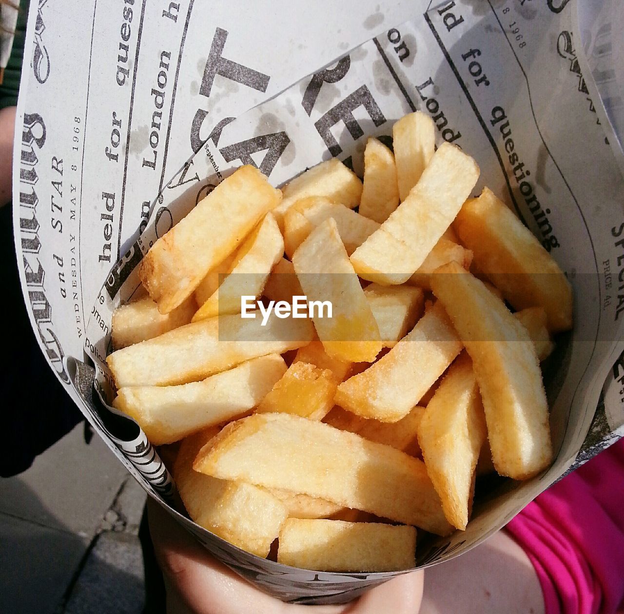 Cropped image of hand holding french fries