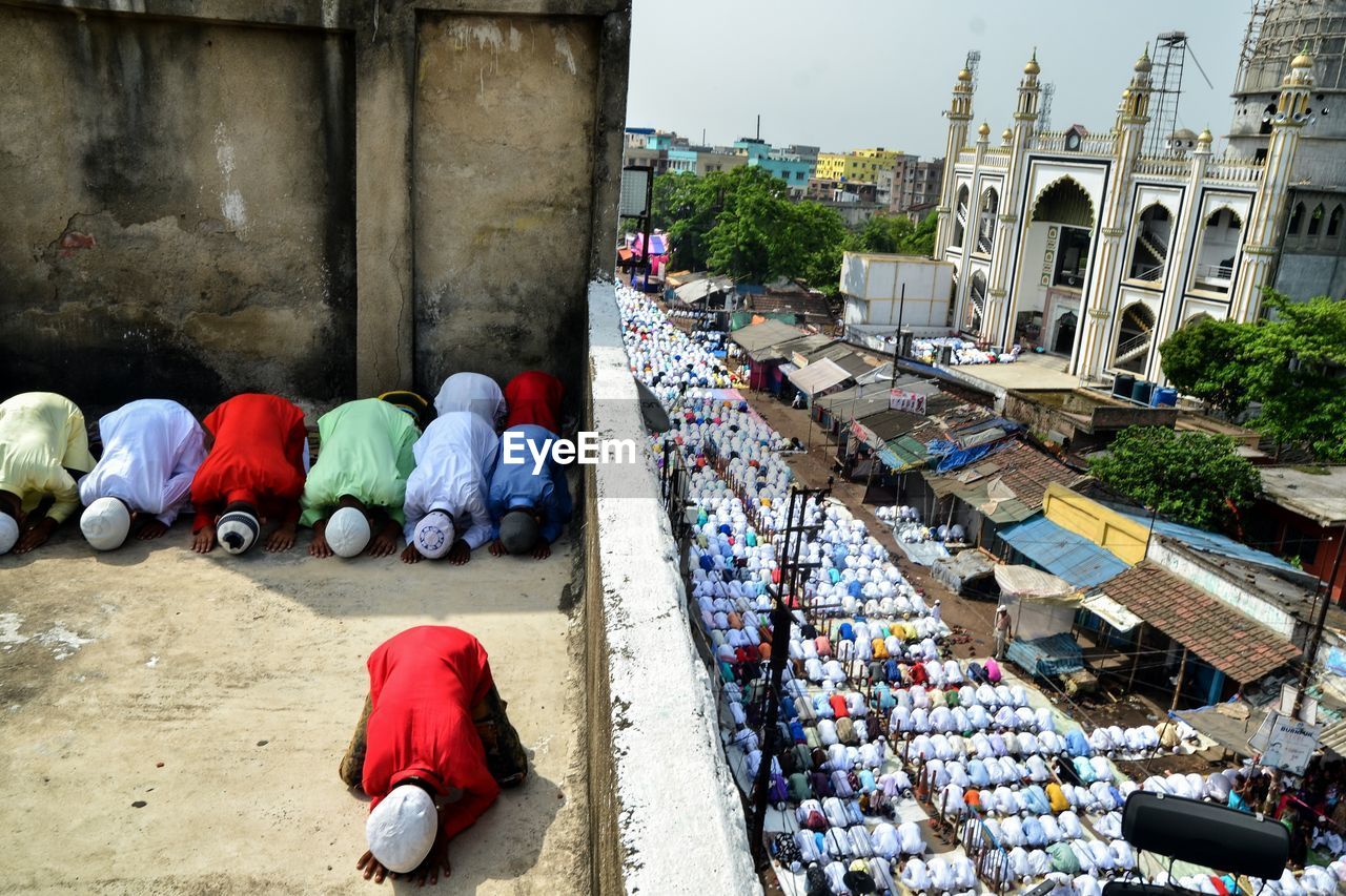 High angle view of people praying on road in city