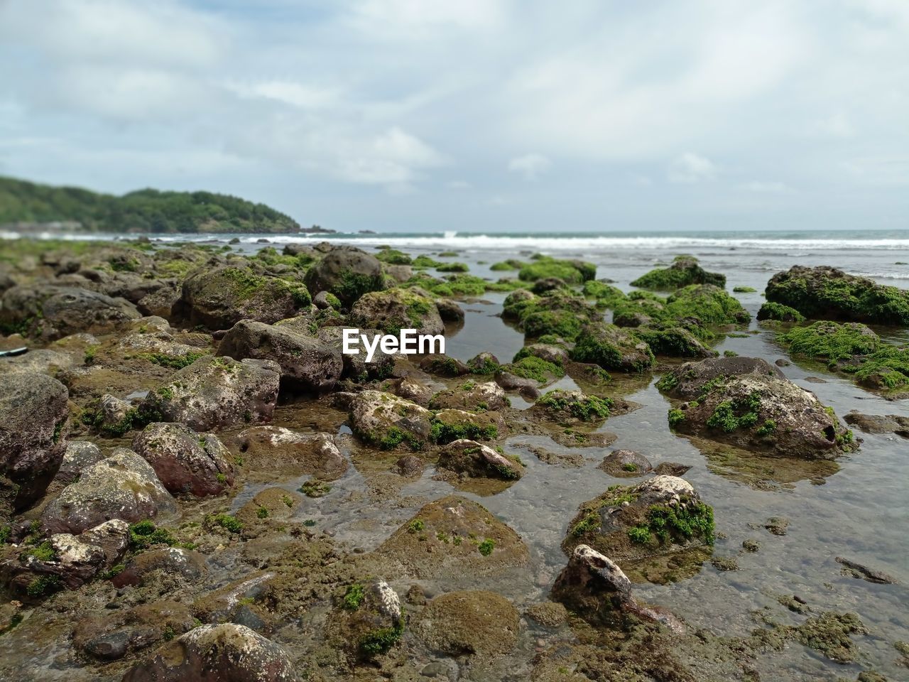 Rocks on beach against sky