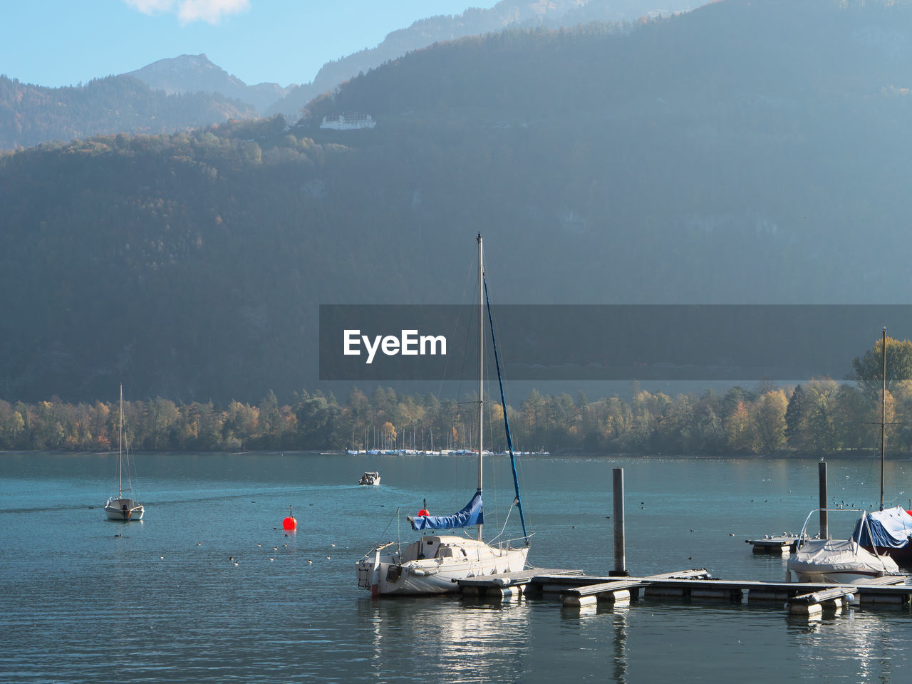 Sailboats in lake against sky