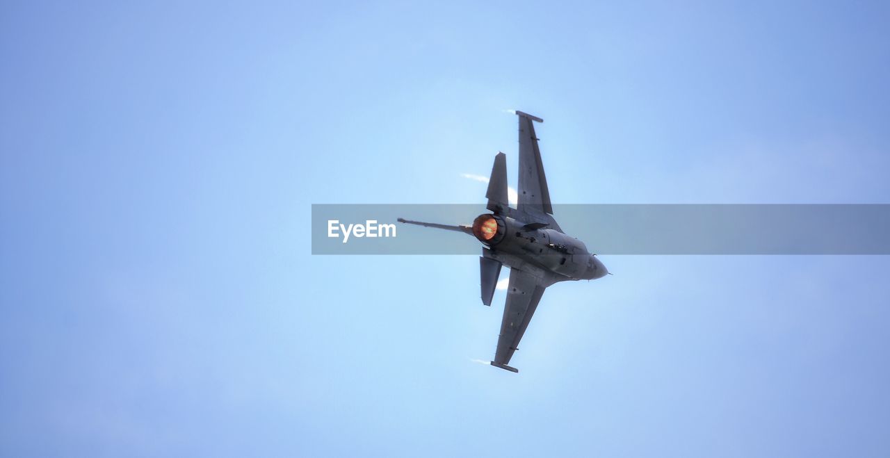 Low angle view of fighter plane flying in clear sky