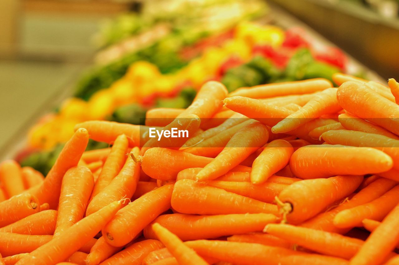 Close-up of vegetables for sale. carrots in foreground. 