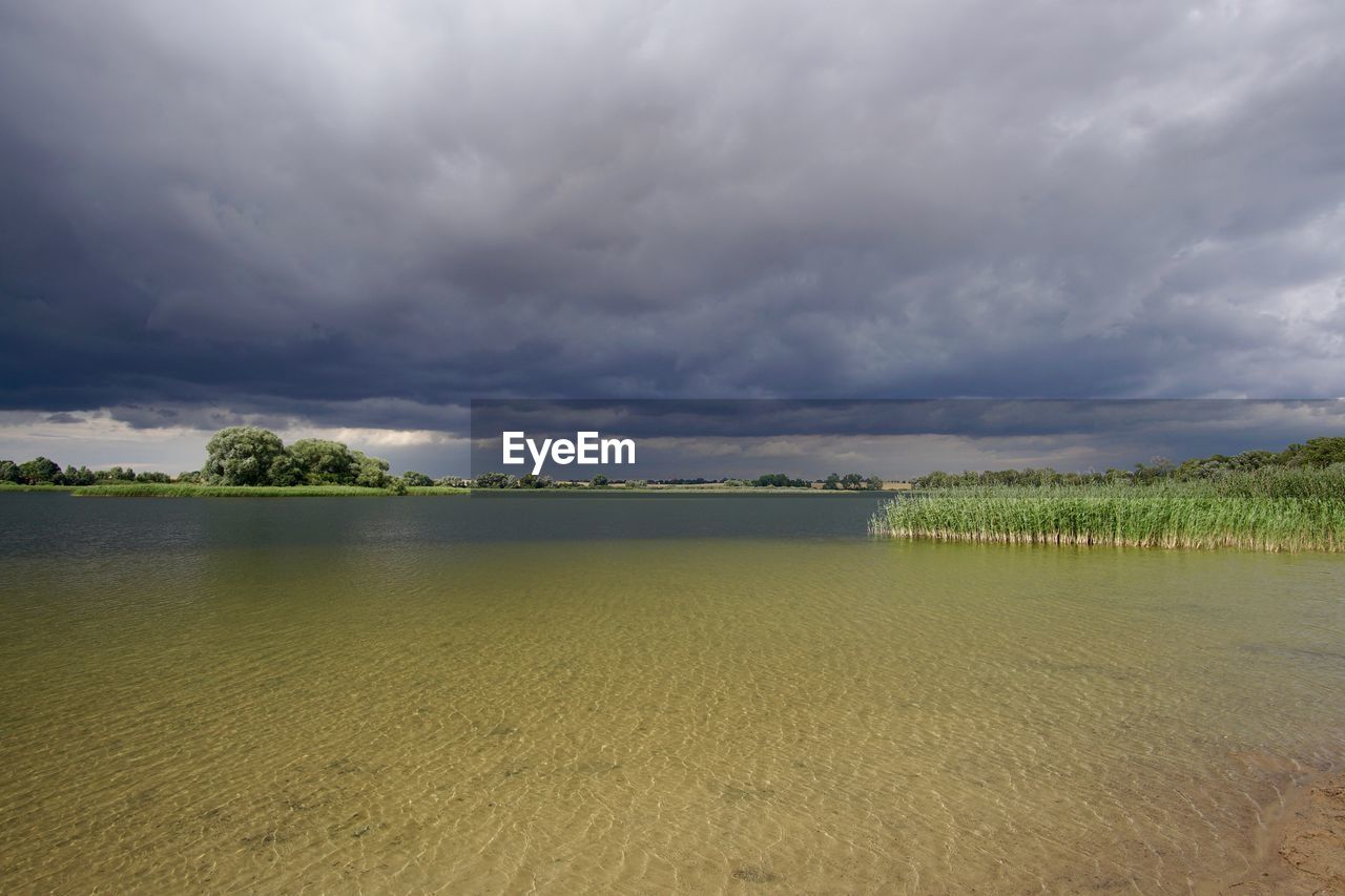 Scenic view of sea against cloudy sky