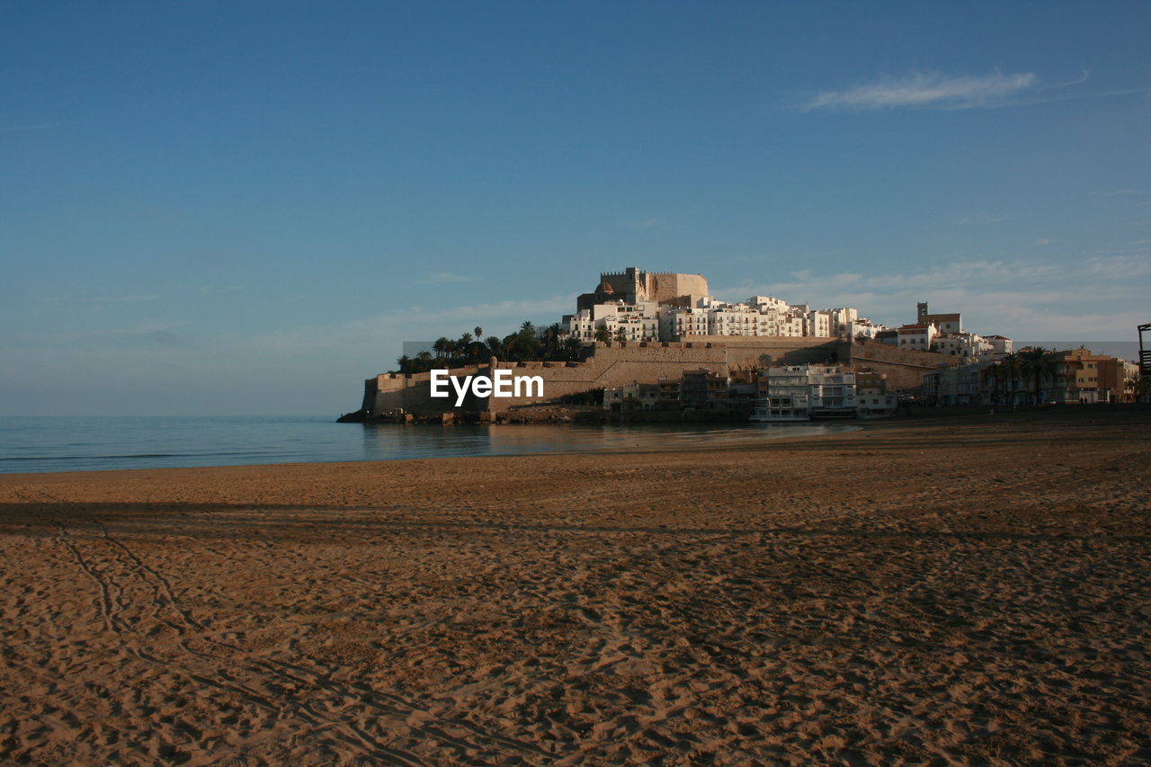 BEACH BY SEA AGAINST BLUE SKY