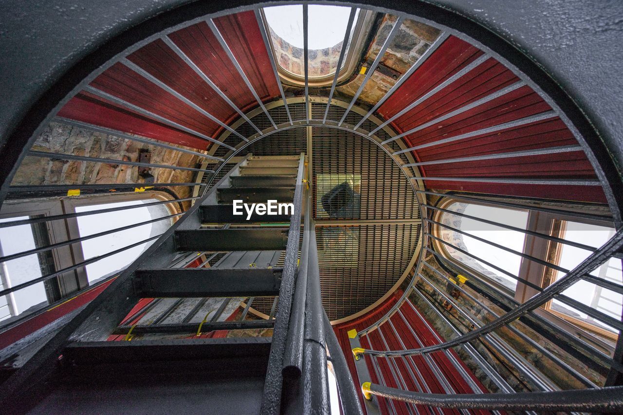 LOW ANGLE VIEW OF EMPTY SPIRAL STAIRCASE IN BUILDING