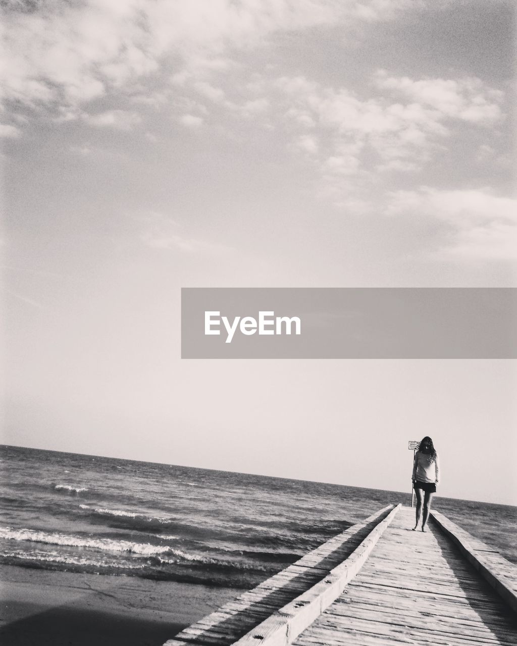 Girl on beach against sky