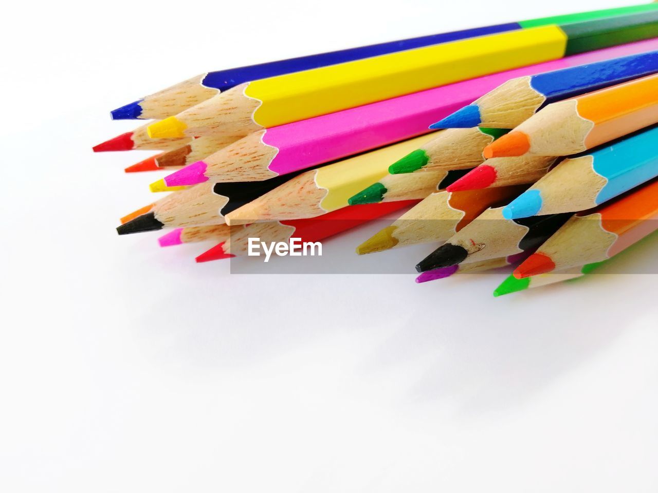 Close-up of multi colored pencils on white background