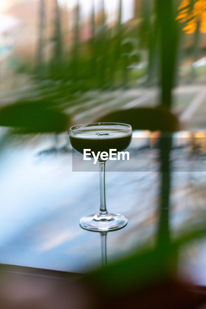 CLOSE-UP OF WINE IN GLASS ON TABLE