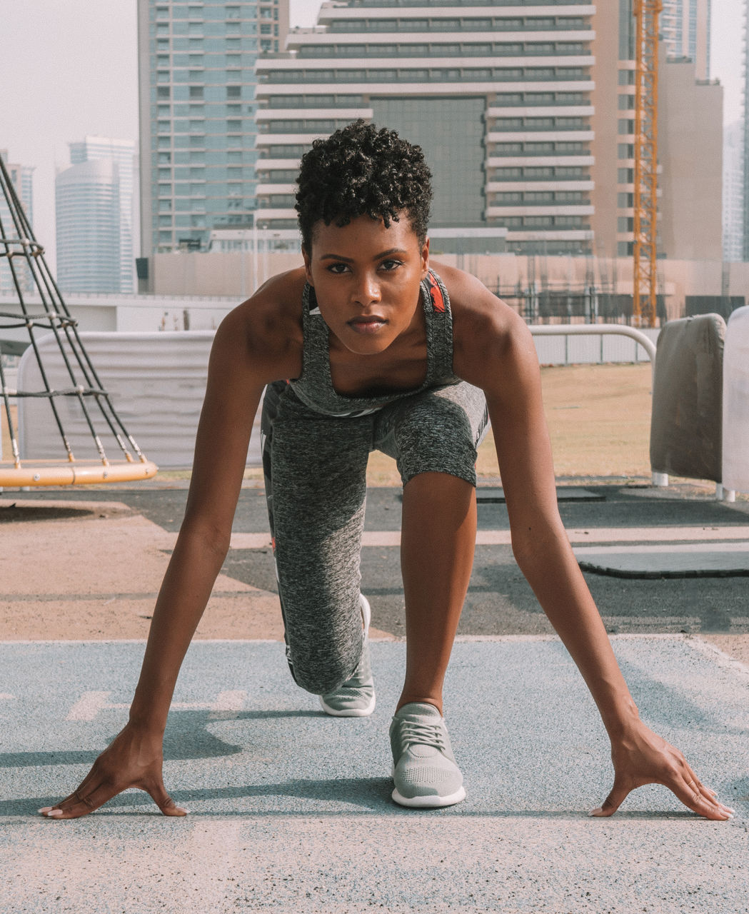 Portrait of woman preparing for race on road