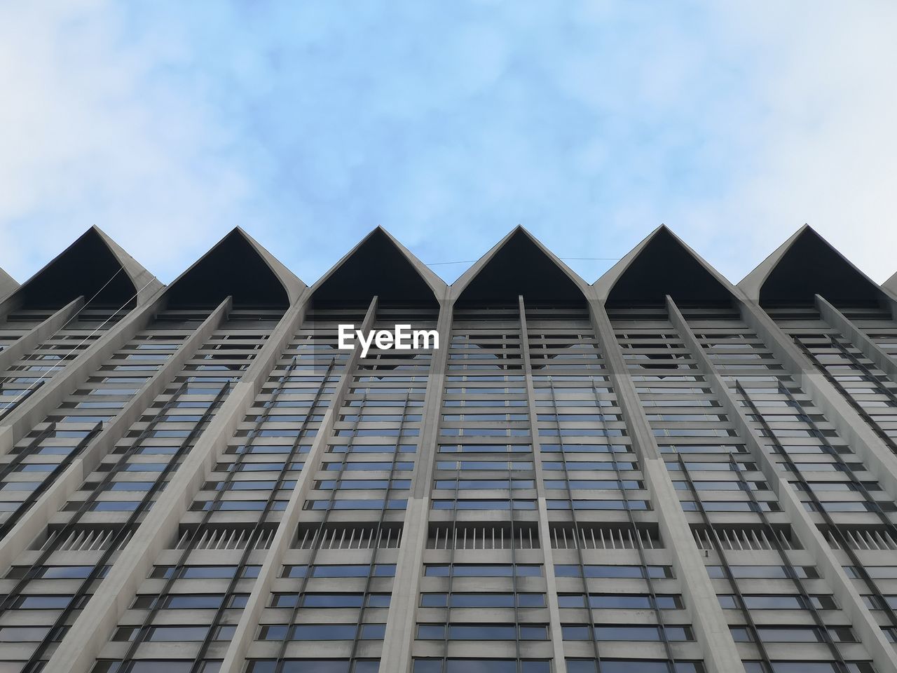 LOW ANGLE VIEW OF OFFICE BUILDING AGAINST SKY