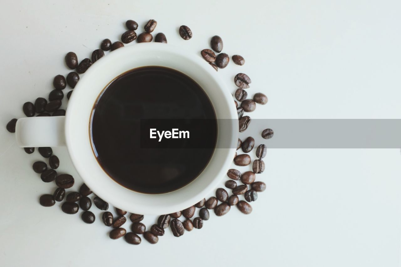 DIRECTLY ABOVE SHOT OF COFFEE CUP OVER BLACK BACKGROUND