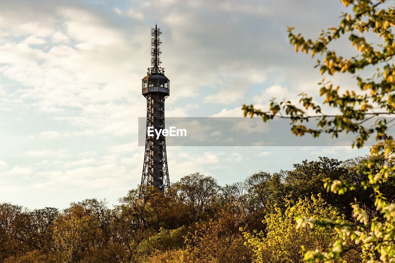 LOW ANGLE VIEW OF TOWER AND BUILDINGS AGAINST CLOUDY SKY