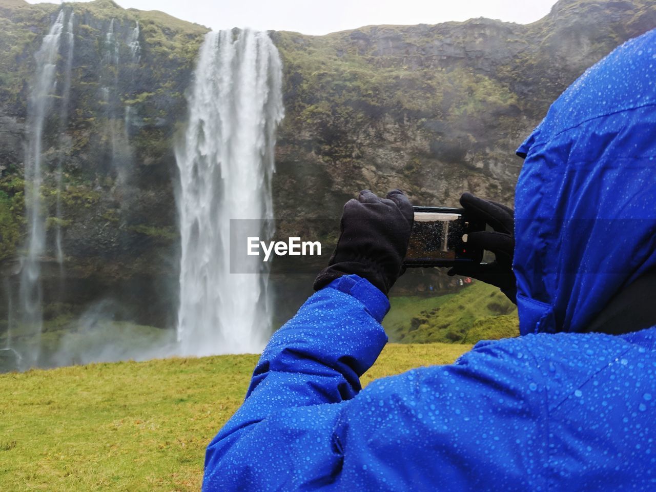 SCENIC VIEW OF WATERFALL IN MOUNTAINS