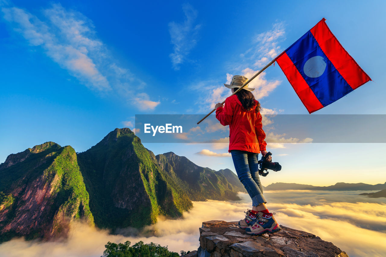 rear view of woman standing on mountain