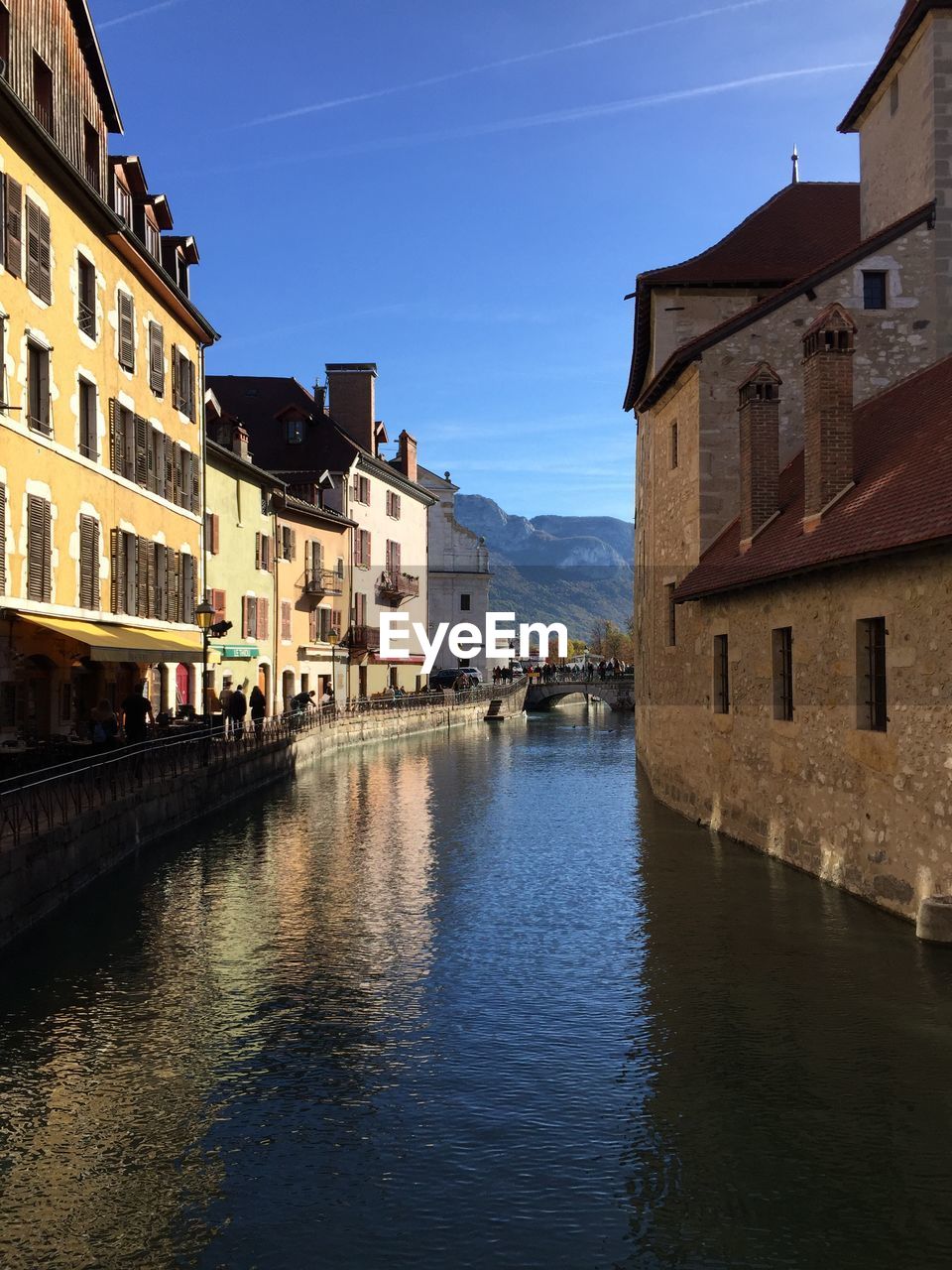 Canal amidst buildings in town against sky