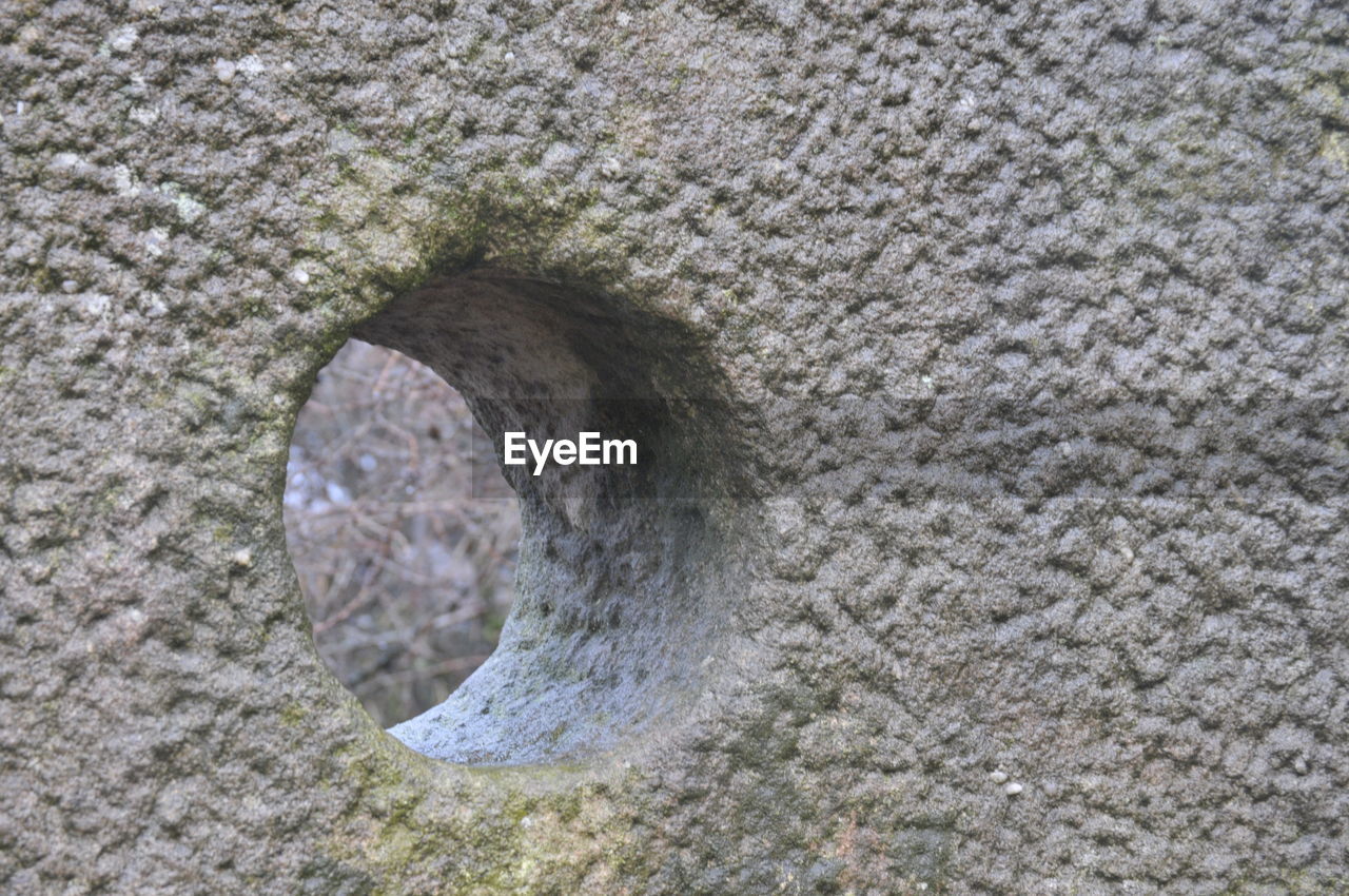 HIGH ANGLE VIEW OF STONE WALL WITH HOLE