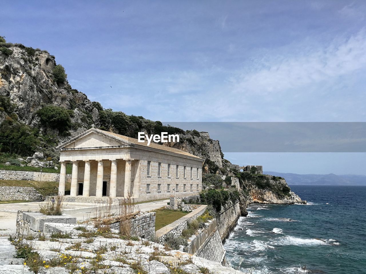 Building by sea against sky