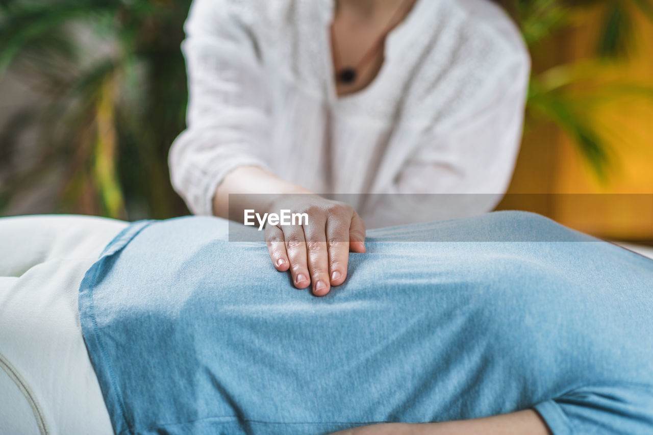 Midsection of woman getting massage at spa