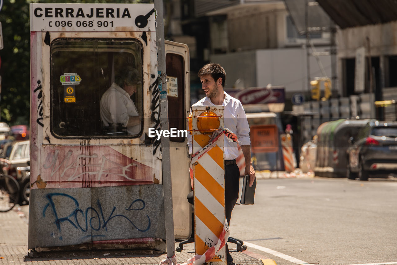 MAN STANDING ON STREET