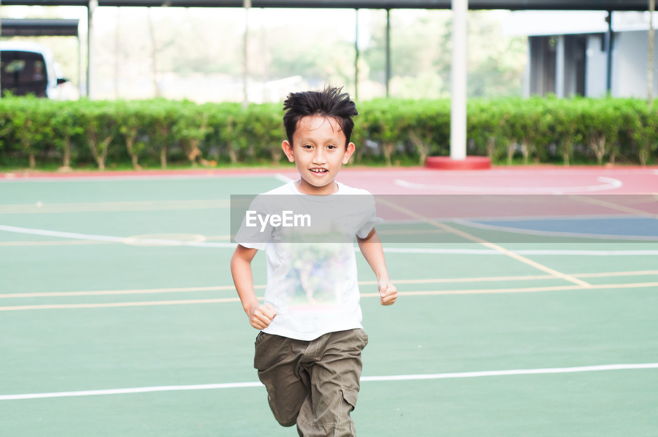 Boy running at basketball court
