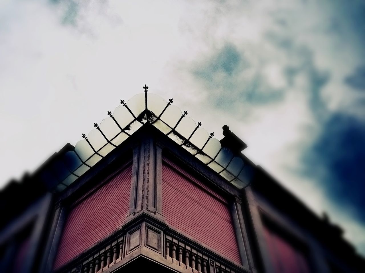 Low angle view of building against cloudy sky