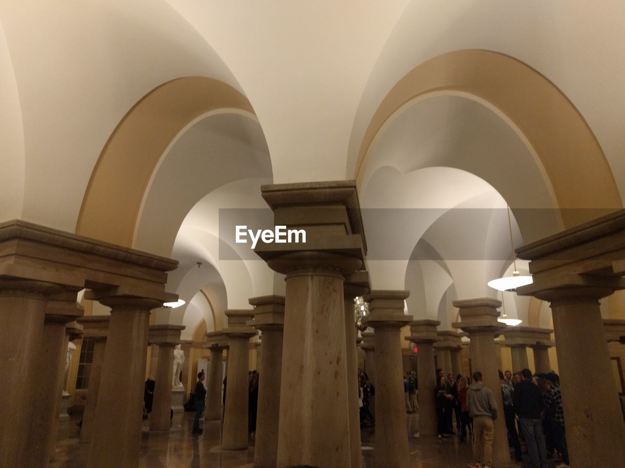 PEOPLE WALKING IN CORRIDOR OF BUILDING