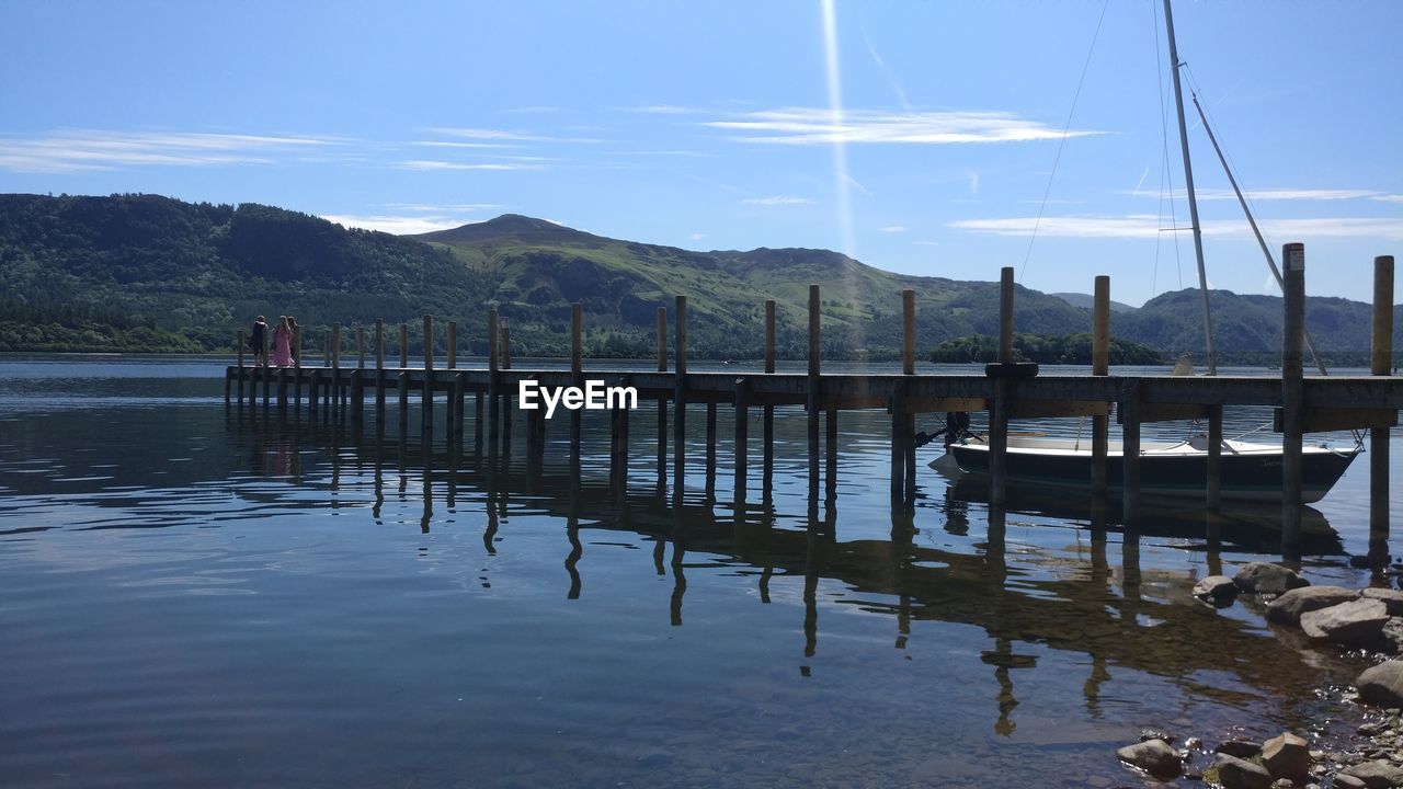 Pier on lake against sky