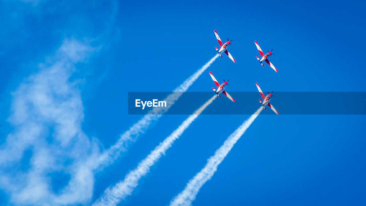 Low angle view of airshow against sky