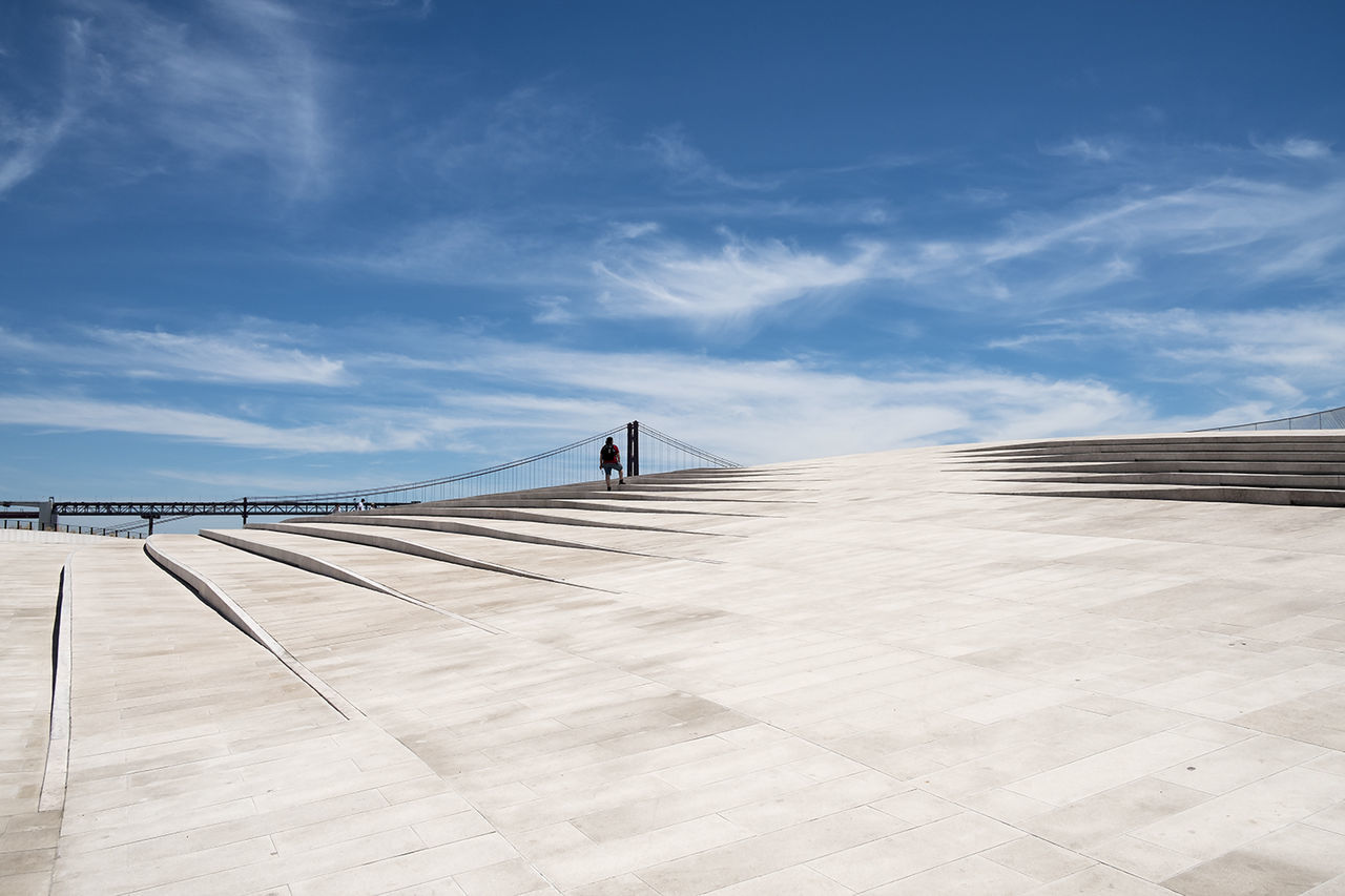 Distant view of person at maat museum against blue sky during sunny day