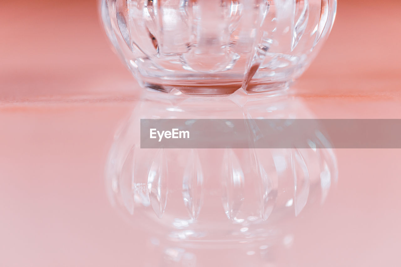 CLOSE-UP OF EMPTY GLASS ON TABLE AGAINST BACKGROUND