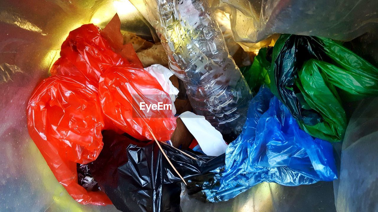 HIGH ANGLE VIEW OF MULTI COLORED CANDIES IN PLASTIC CONTAINER