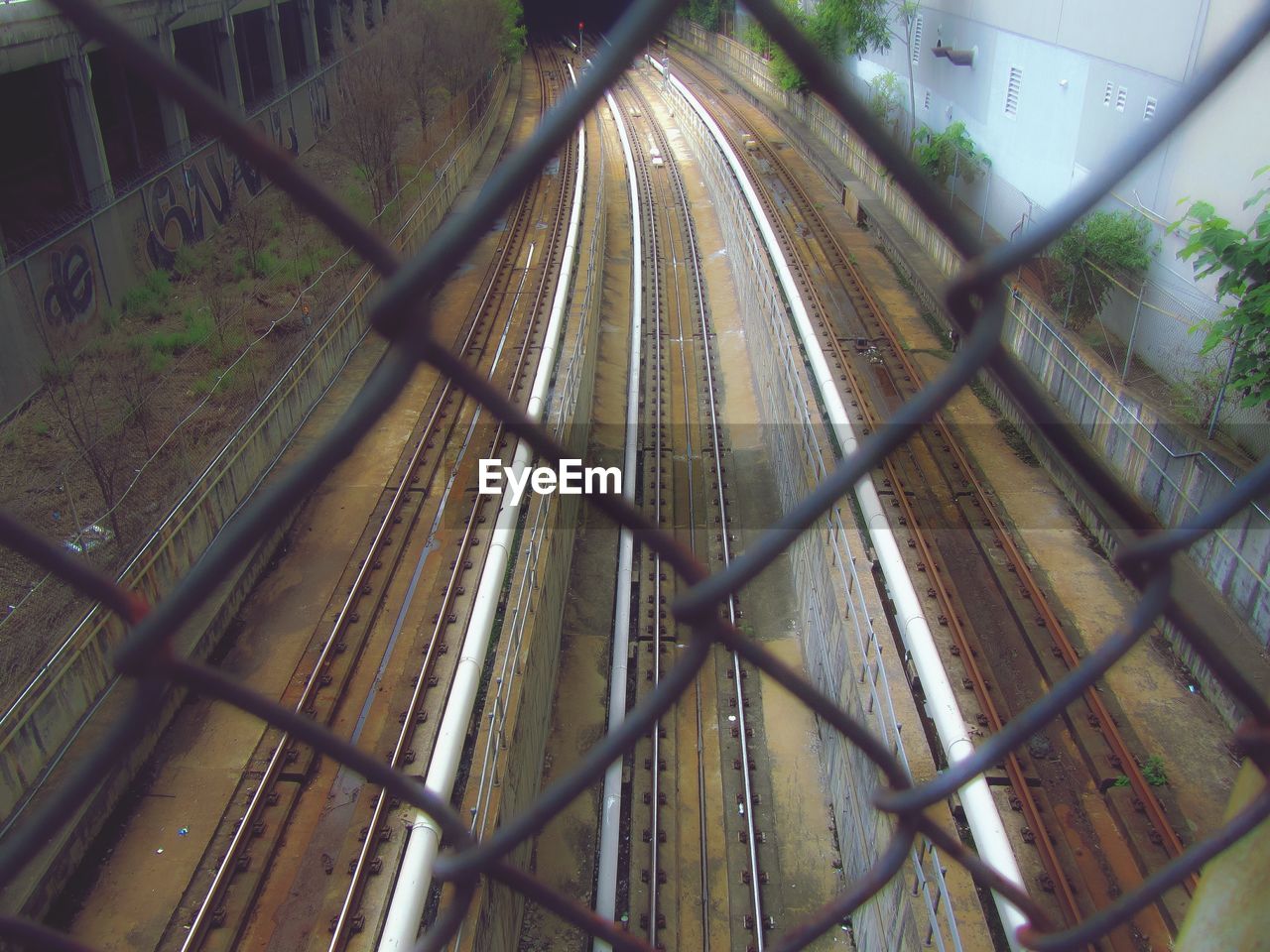 Railroad track visible behind chainlink fence