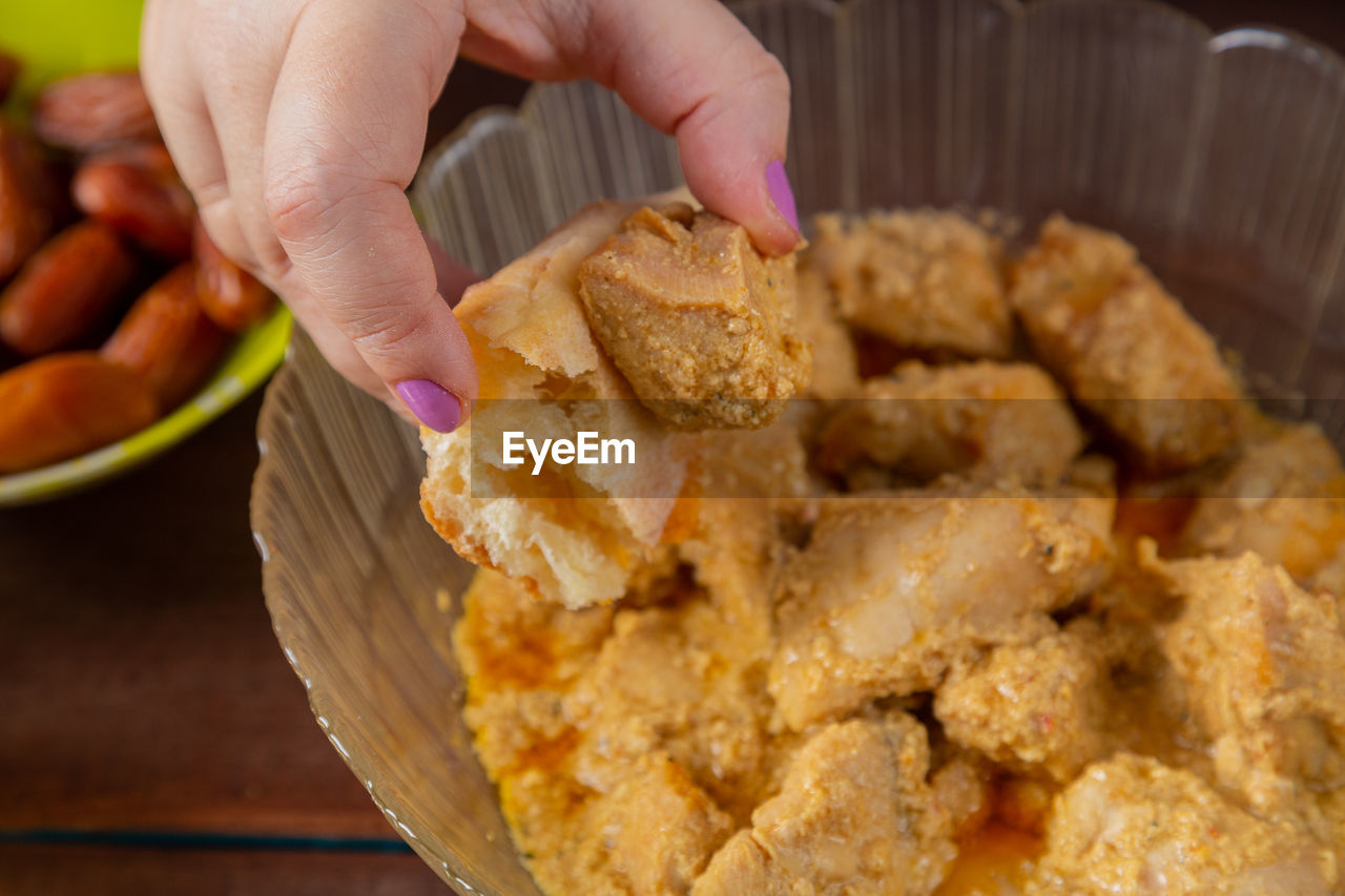 food, food and drink, hand, dish, one person, freshness, produce, holding, fried food, meal, close-up, fast food, breakfast, baked, adult, dessert, snack, sweet food, indoors, cuisine, unhealthy eating, focus on foreground