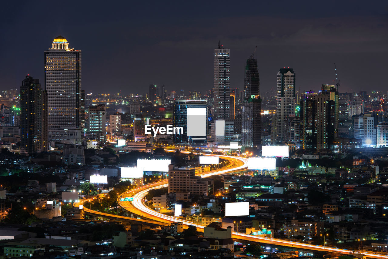 ILLUMINATED BUILDINGS AGAINST SKY AT NIGHT