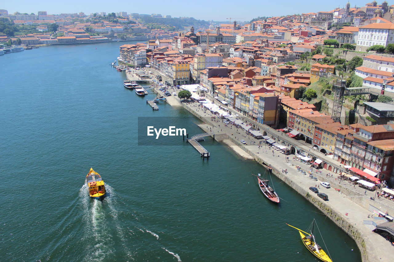 Boats in river against buildings