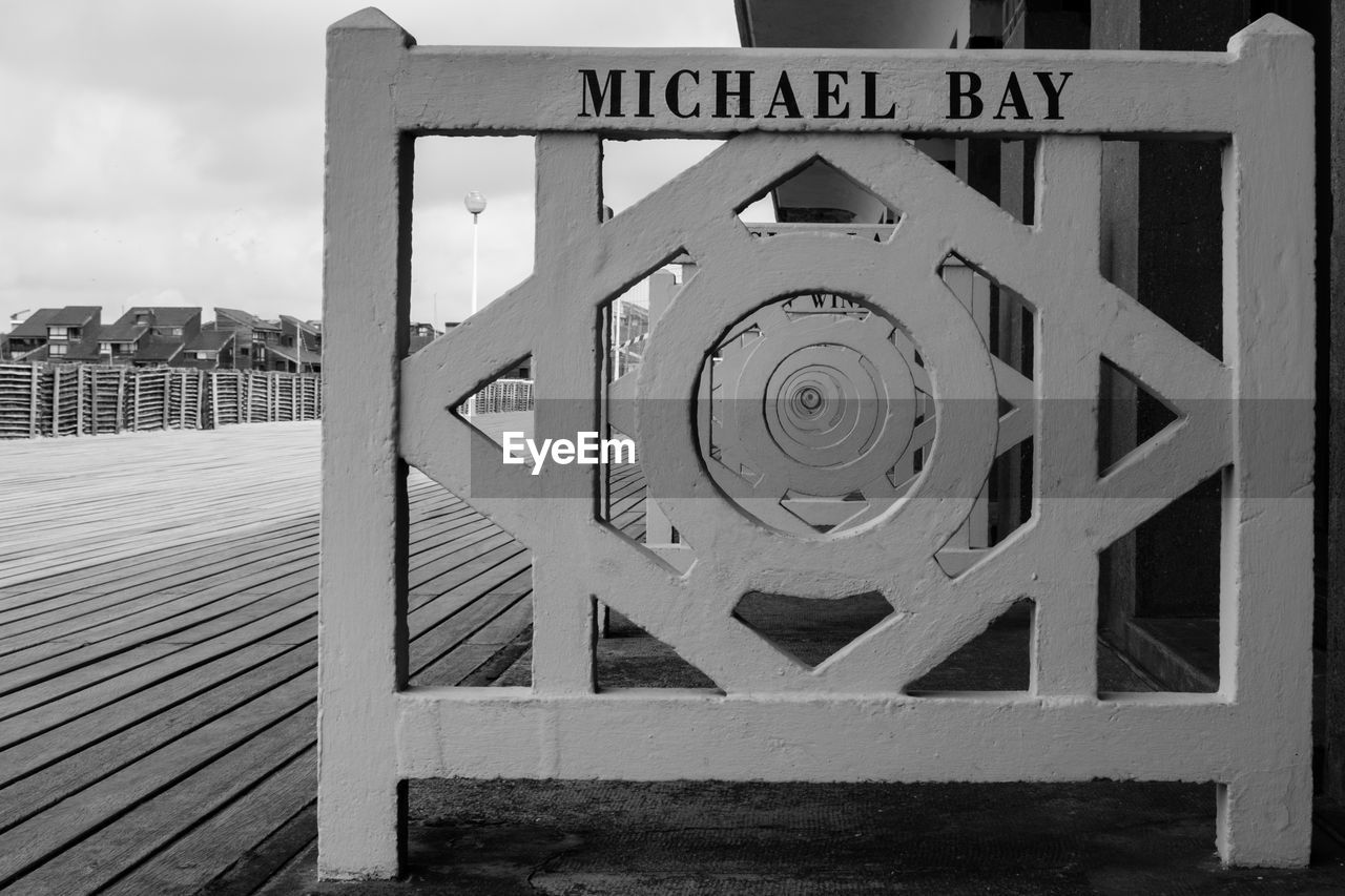 Text on railing by boardwalk