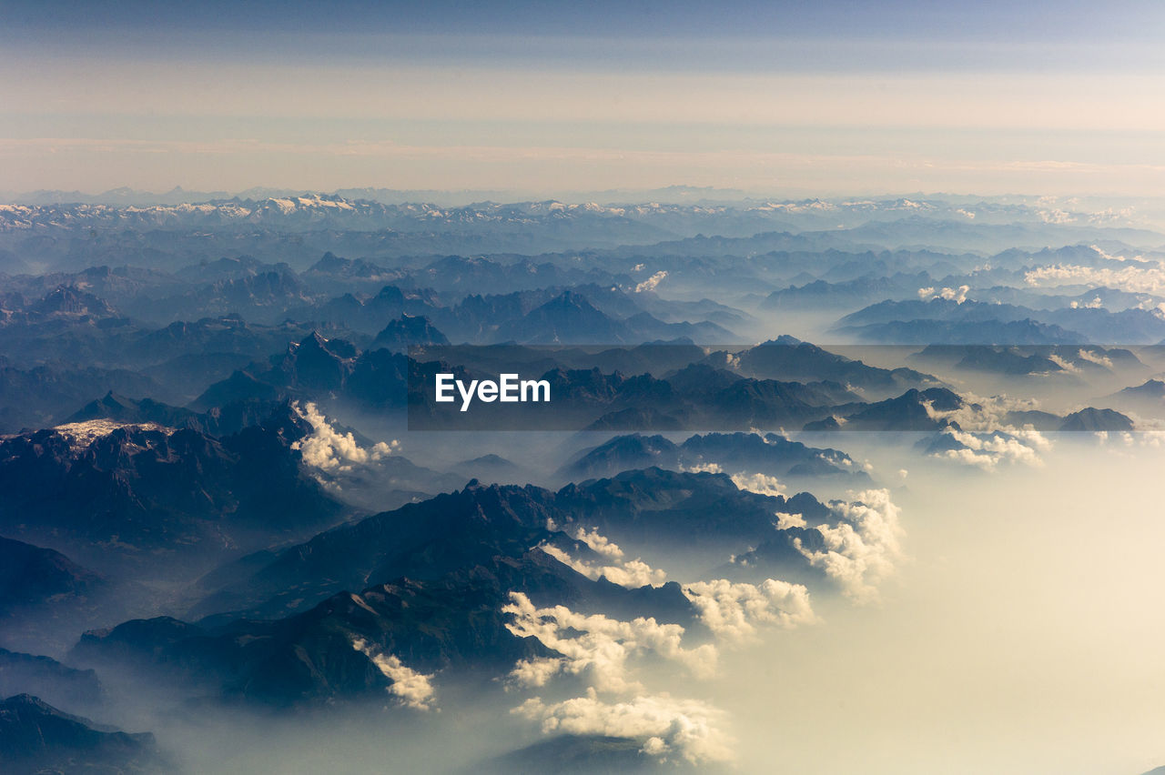 Aerial view of mountains against sky during sunrise