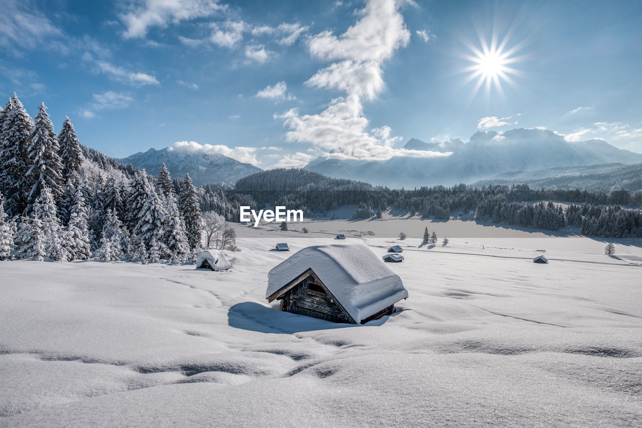 Scenic view of snow covered mountains against sky