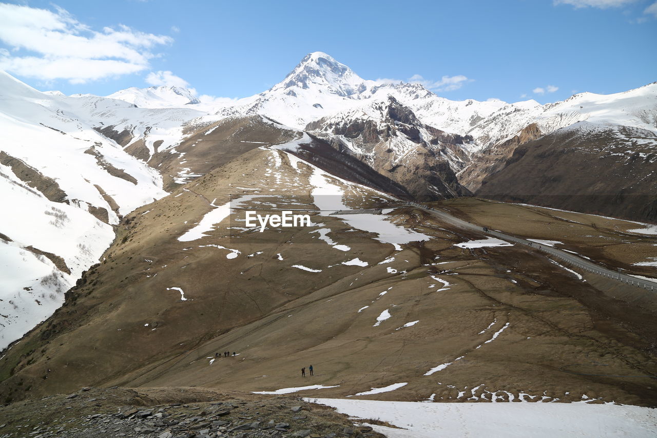 SCENIC VIEW OF SNOWCAPPED MOUNTAINS AGAINST SKY DURING WINTER