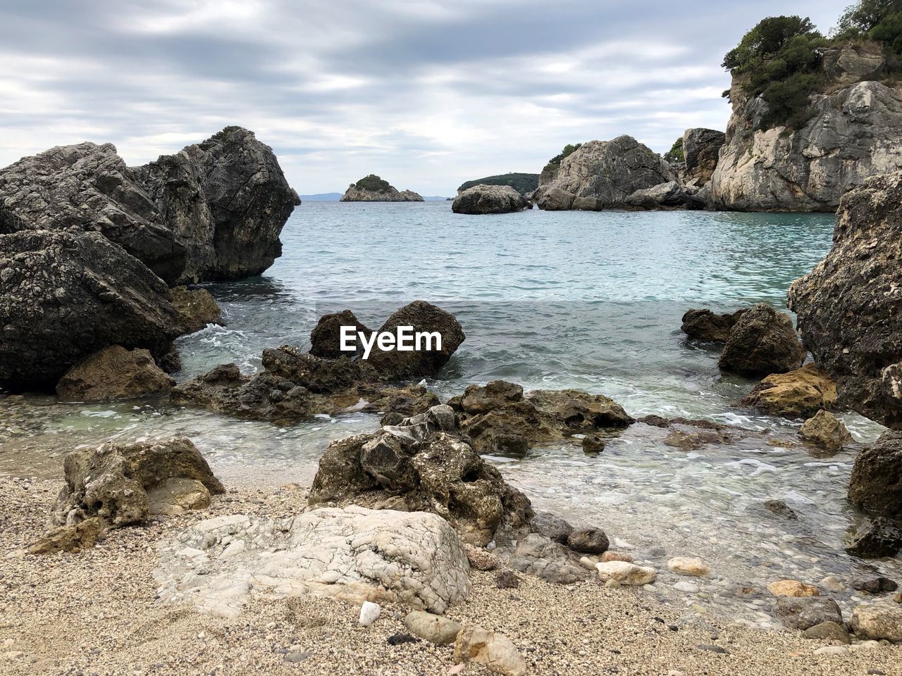 Rocks on beach against sky