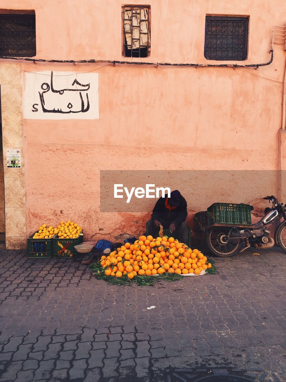 Man selling oranges in street market