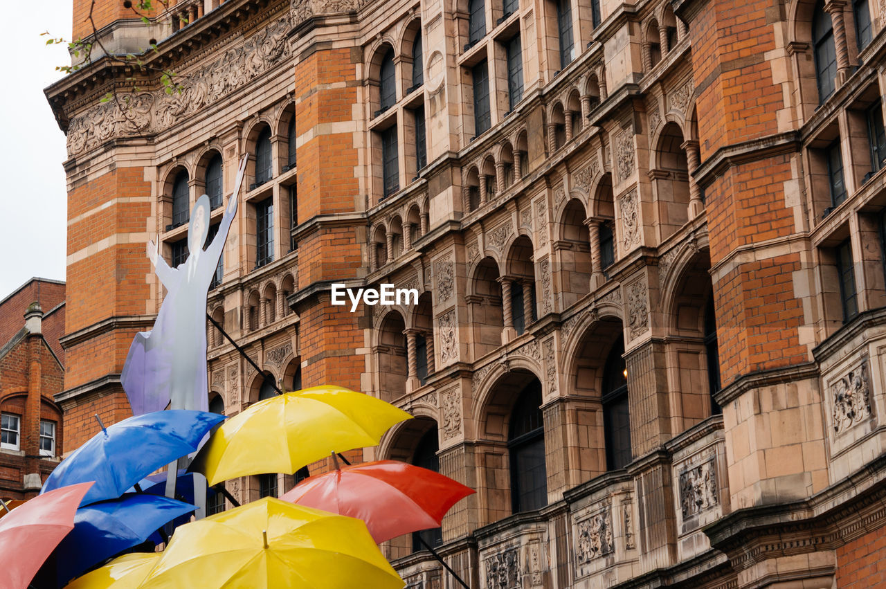 Colorful umbrellas in front of an old building